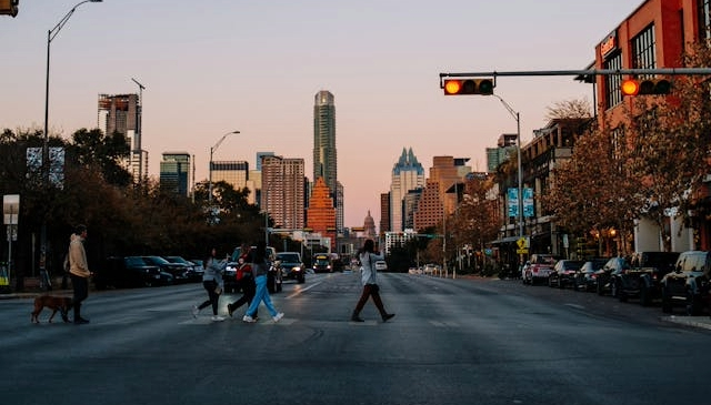 Evening view of an Austin street with people crossing.