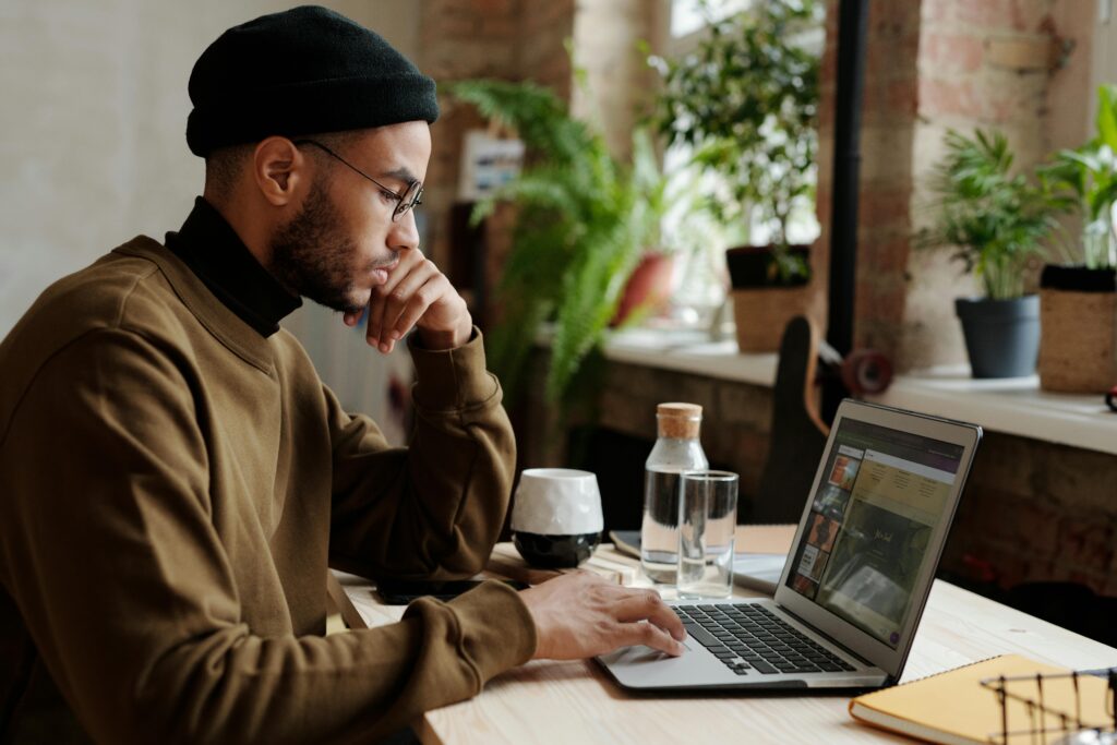 A boy sitting and looking his laptop screen